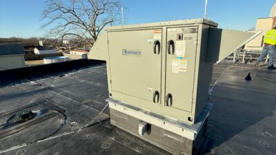 Figure 1: An energy recovery ventilator (ERV) unit installed at an administration building in Massachusetts. The ERV exchanges heat between the outdoor air and the ventilation from the occupied spaces. It operates in air-side economizer mode when the outdoor air temperature is below 60°F and modulates the outside air damper and return air damper to maintain the mixed air temperature setpoint. Courtesy: CDM Smith