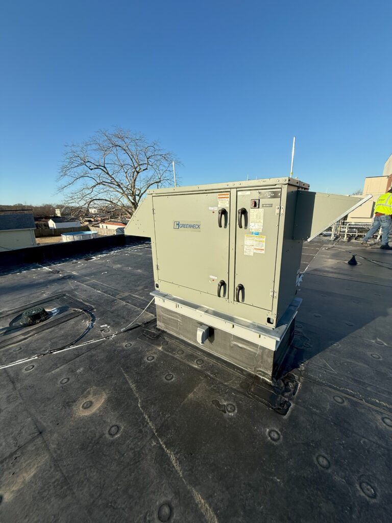 Figure 1: An energy recovery ventilator (ERV) unit installed at an administration building in Massachusetts. The ERV exchanges heat between the outdoor air and the ventilation from the occupied spaces. It operates in air-side economizer mode when the outdoor air temperature is below 60°F and modulates the outside air damper and return air damper to maintain the mixed air temperature setpoint. Courtesy: CDM Smith