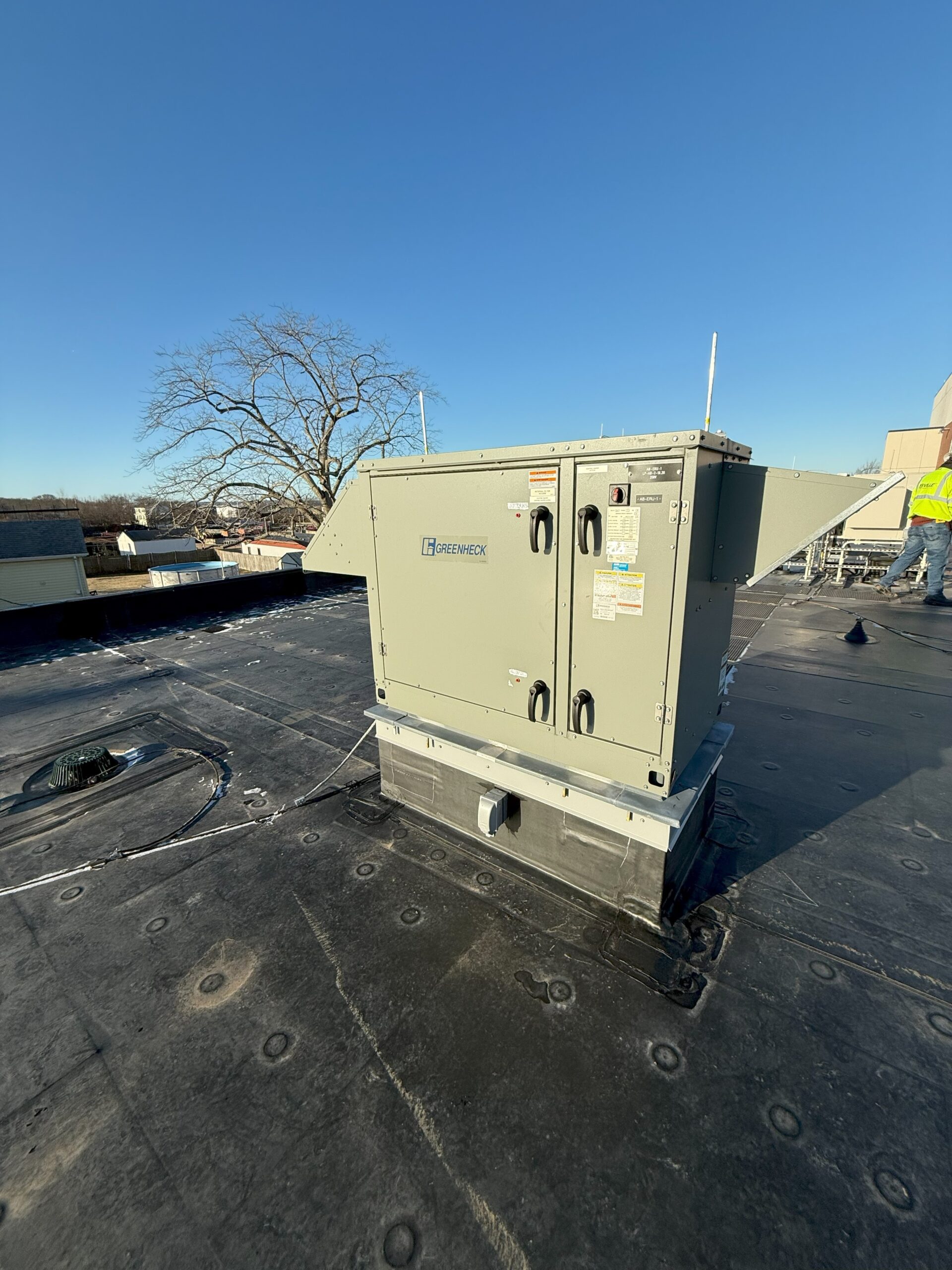 Figure 1: An energy recovery ventilator (ERV) unit installed at an administration building in Massachusetts. The ERV exchanges heat between the outdoor air and the ventilation from the occupied spaces. It operates in air-side economizer mode when the outdoor air temperature is below 60°F and modulates the outside air damper and return air damper to maintain the mixed air temperature setpoint. Courtesy: CDM Smith