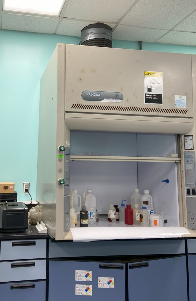 Figure 3: A fume hood for chemical fume exhaust. The duct is seen at the top of the fume hood, which is connected to a fume hood exhaust fan on the roof. Courtesy: CDM Smith