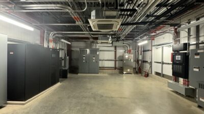 Figure 4. The main electrical room from a lab expansion with uninterruptable power supply, main switchboard and optional loads automatic transfer switch. Courtesy: CDM Smith