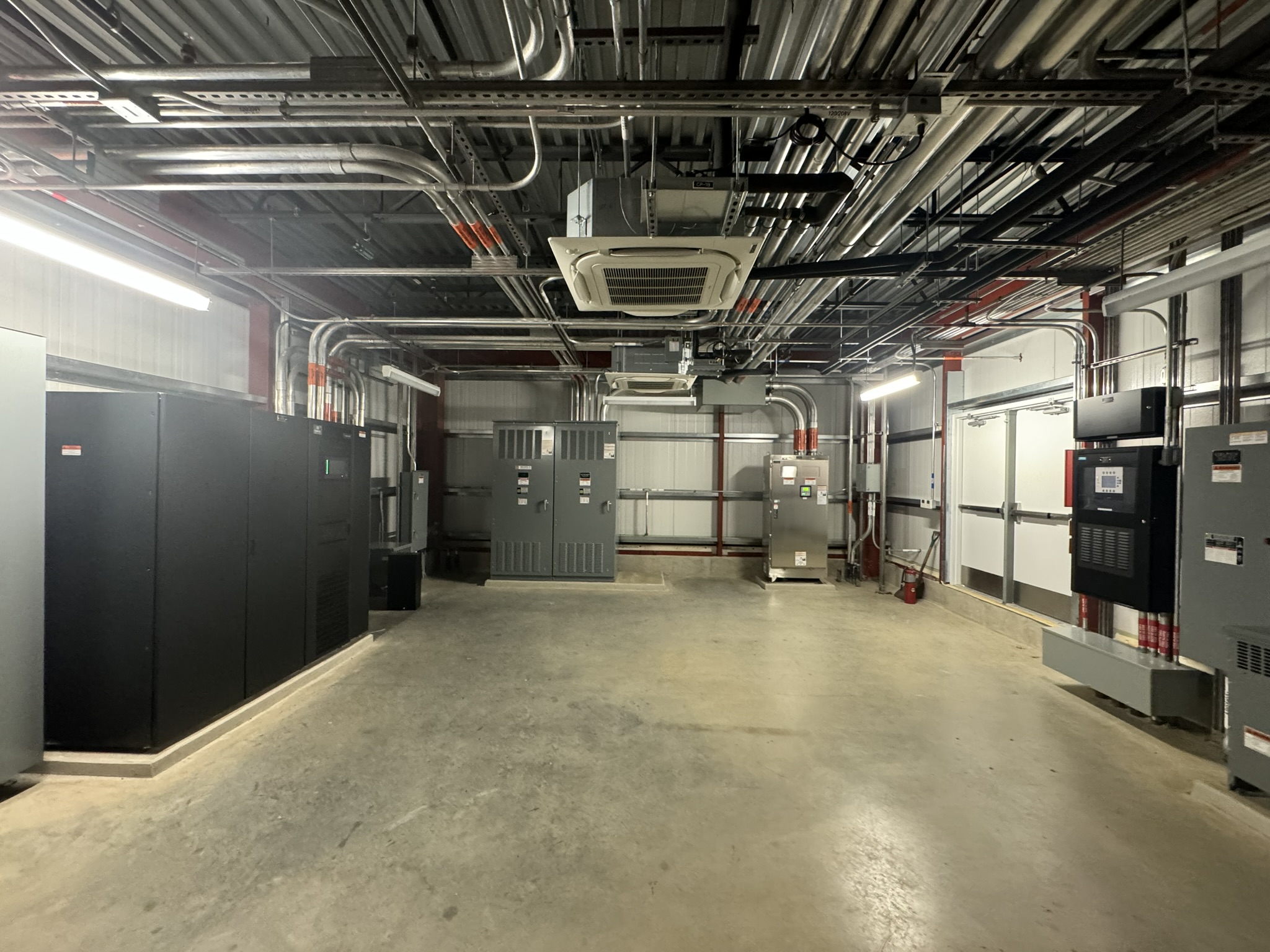 Figure 4. The main electrical room from a lab expansion with uninterruptable power supply, main switchboard and optional loads automatic transfer switch. Courtesy: CDM Smith