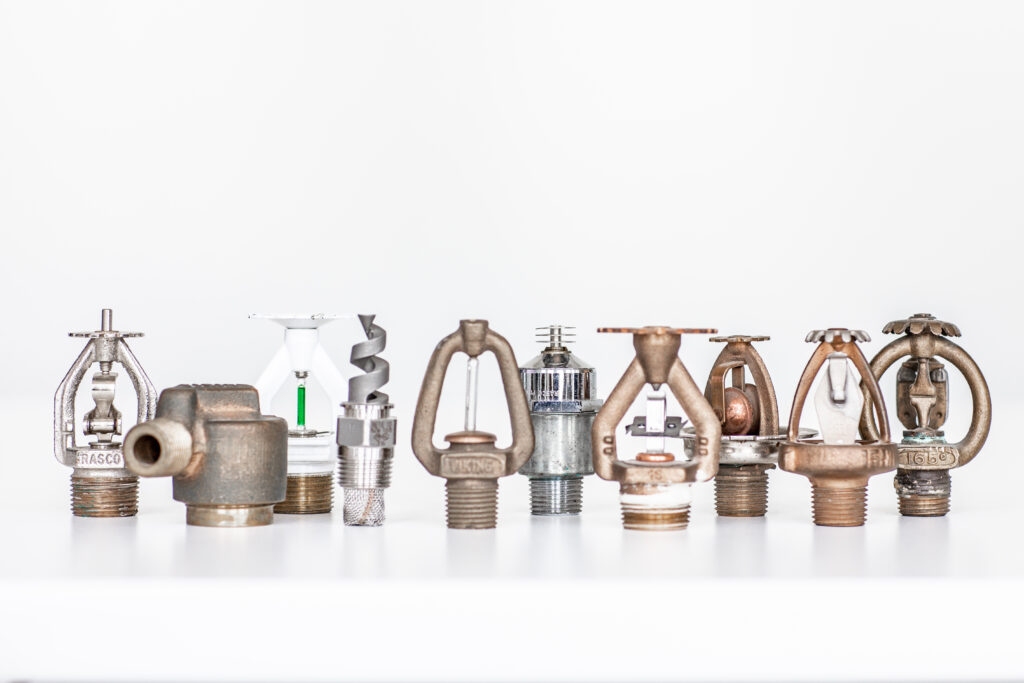 Figure 2: A variety of fire sprinklers and nozzles are displayed, showcasing different types of discharge devices used in fire suppression systems. Courtesy: HDR