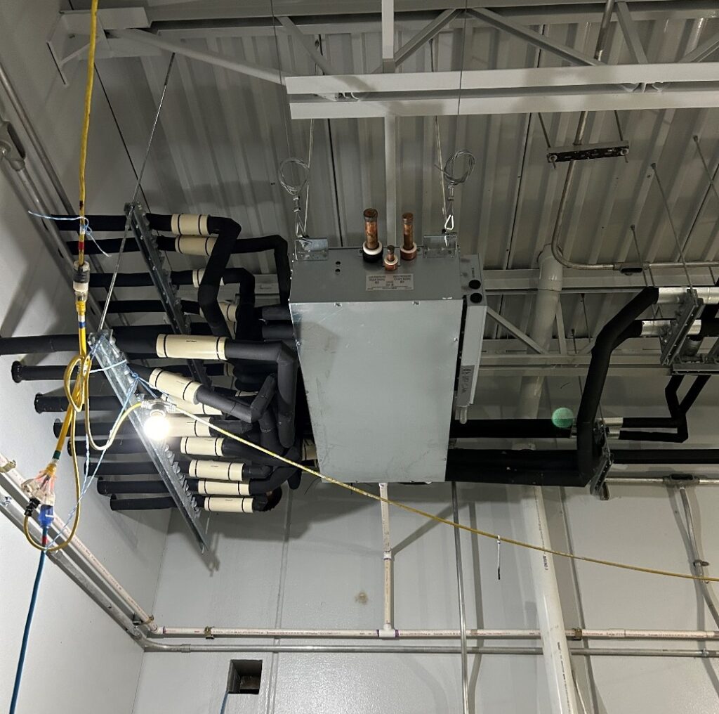 Figure 2: A heat recovery variable refrigerant flow branch controller in a mechanical room. Courtesy: CDM Smith