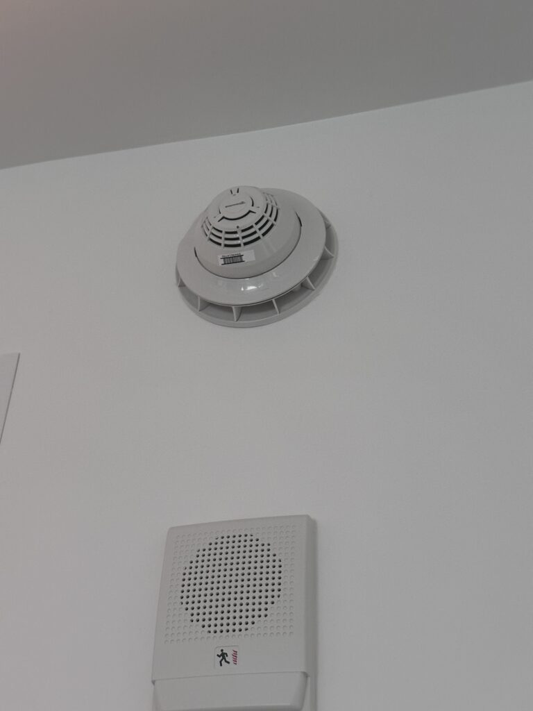 Smoke detectors with a low frequency sounder base. Both speakers and sounder bases can produce the 520 hertz required in sleeping areas. Courtesy: McGuire Engineers Inc.
