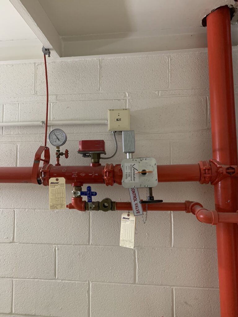 Figure 2: Sprinkler floor control assembly with waterflow switch and valve position indicator monitored by the fire alarm system. Courtesy: Ray Grill Consulting