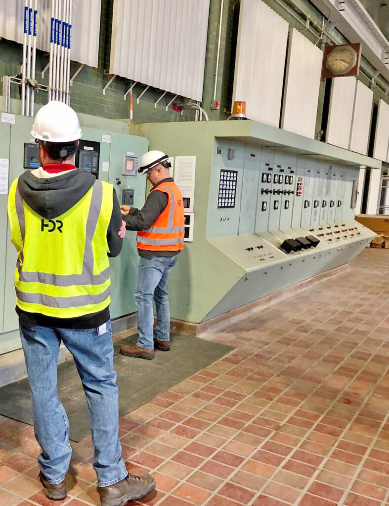 Figure 5: Photos of control systems engineers performing a field investigation to develop a replacement approach for controller locations in a working facility. Courtesy: HDR