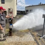 Fire hydrant flushing in progress with hydrant outlet fully open to discharge water at high velocity. This controlled release is used to clear sediment and debris from the water main, verify hydrant operation and evaluate general system performance. Courtesy: CDM Smith