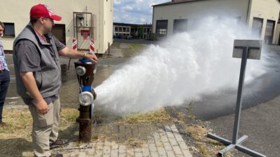 Fire hydrant flushing in progress with hydrant outlet fully open to discharge water at high velocity. This controlled release is used to clear sediment and debris from the water main, verify hydrant operation and evaluate general system performance. Courtesy: CDM Smith