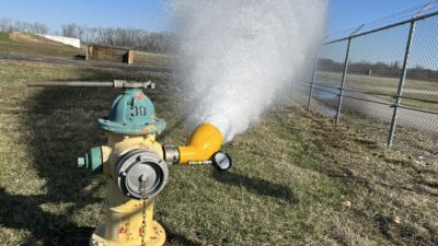 Fire hydrant flow testing provides valuable input data for the development of water infrastructure, assisting in community planning. In this setup, the diffuser is attached to a hydrant outlet and directs discharged water away from the hydrant. The diffuser enables high-volume flow to be released safely even in constrained or landscaped areas. Courtesy: CDM Smith