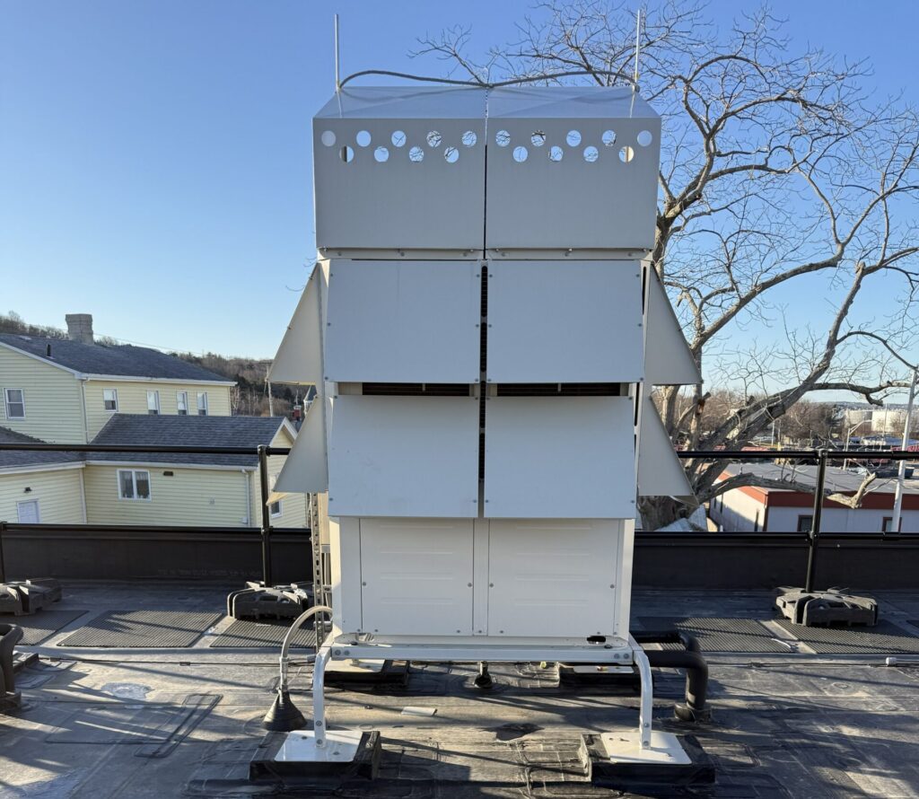 Figure 4: A split-system air-source heat pump installed at an administration building in Massachusetts. The outdoor condenser unit is on the roof (pictured), with an indoor unit located inside the space. Refrigerant is circulated between the outdoor condensing unit and the indoor evaporator, providing both heat and cooling to the space at high efficiencies. Courtesy: CDM Smith
