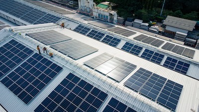 Solar cells on the roof of a large industrial factory. Courtesy: Chayakorn – stock.adobe.com