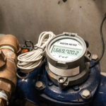Water meter in building with commercial and residential units. Digital measuring device for water usage of property and accuracy in billing of water consumption.