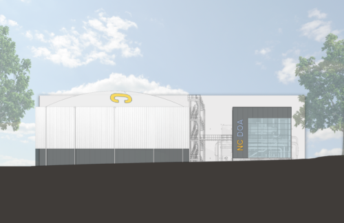 Figure 2: The west side view of the plant shows its outdoor cooling towers and access staircase. The first floor houses the plant's electrical room and pumping area, with the second dedicated to the chillers. Courtesy: Flad Architects